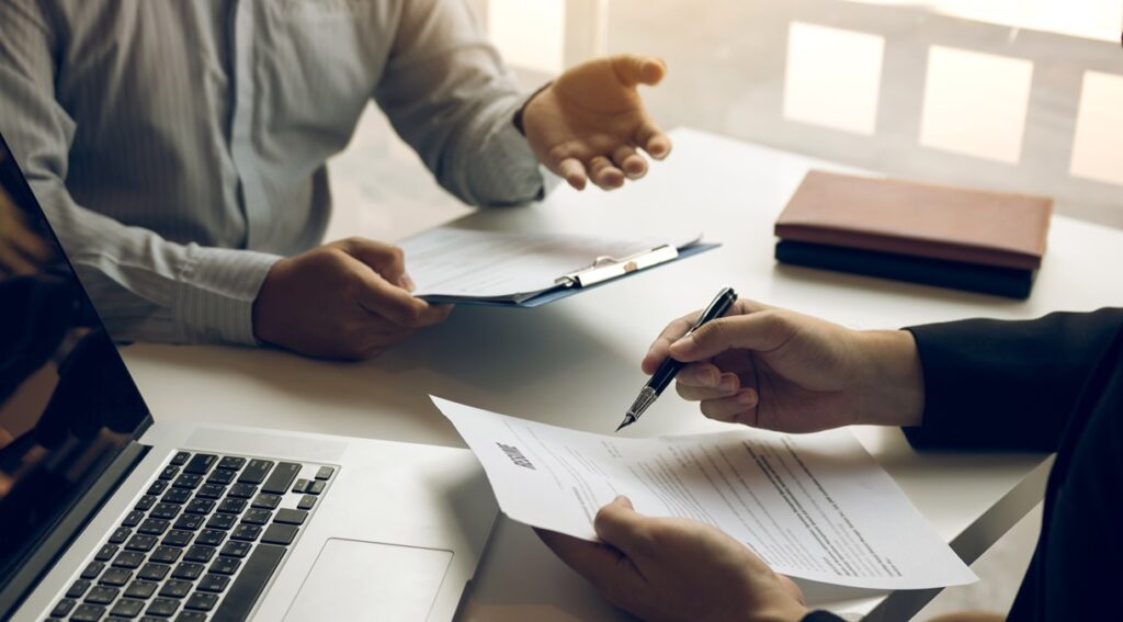 smart businessman professional man in suit executive gesturing and talking in meeting with interview employee about work in modern office.